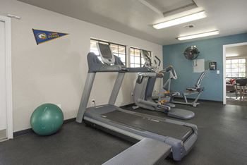 Gym with fitness equipment  l The Edge Apartments in Davis, CA